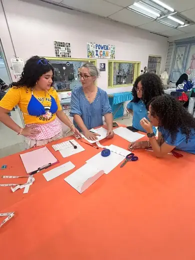 Professor Lilliam Cordero guiding a patternmaking activity.