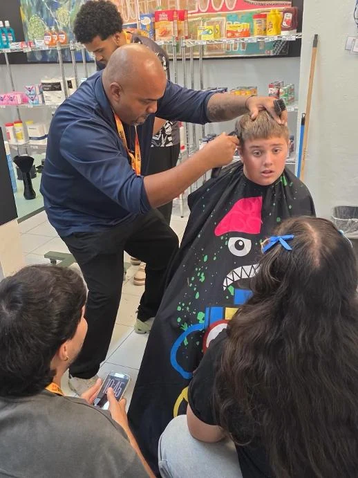 Professor Orfy Sosa leading a barbering demonstration with students