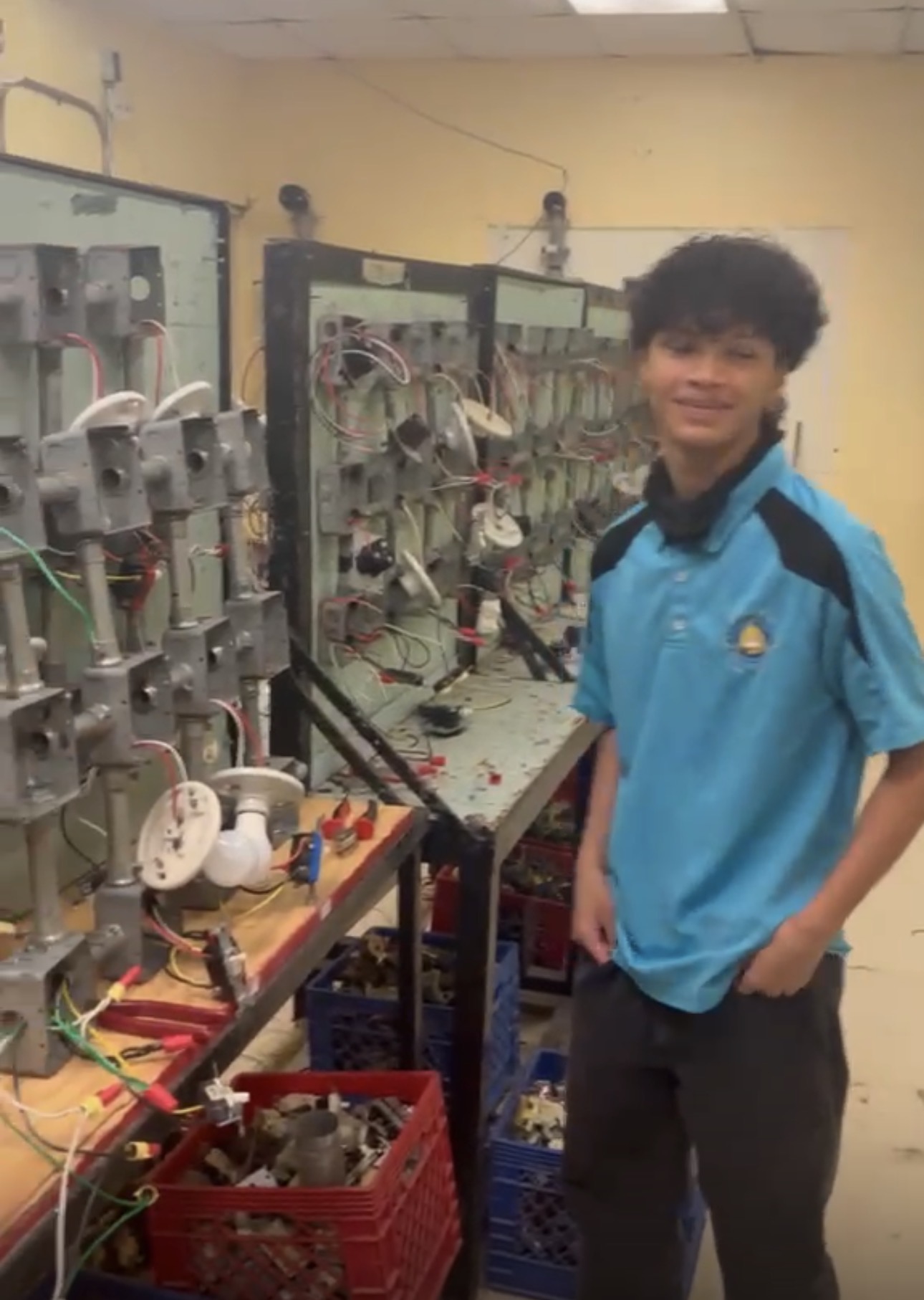 Electricity with PLC and Renewable Energy student next to practice panels