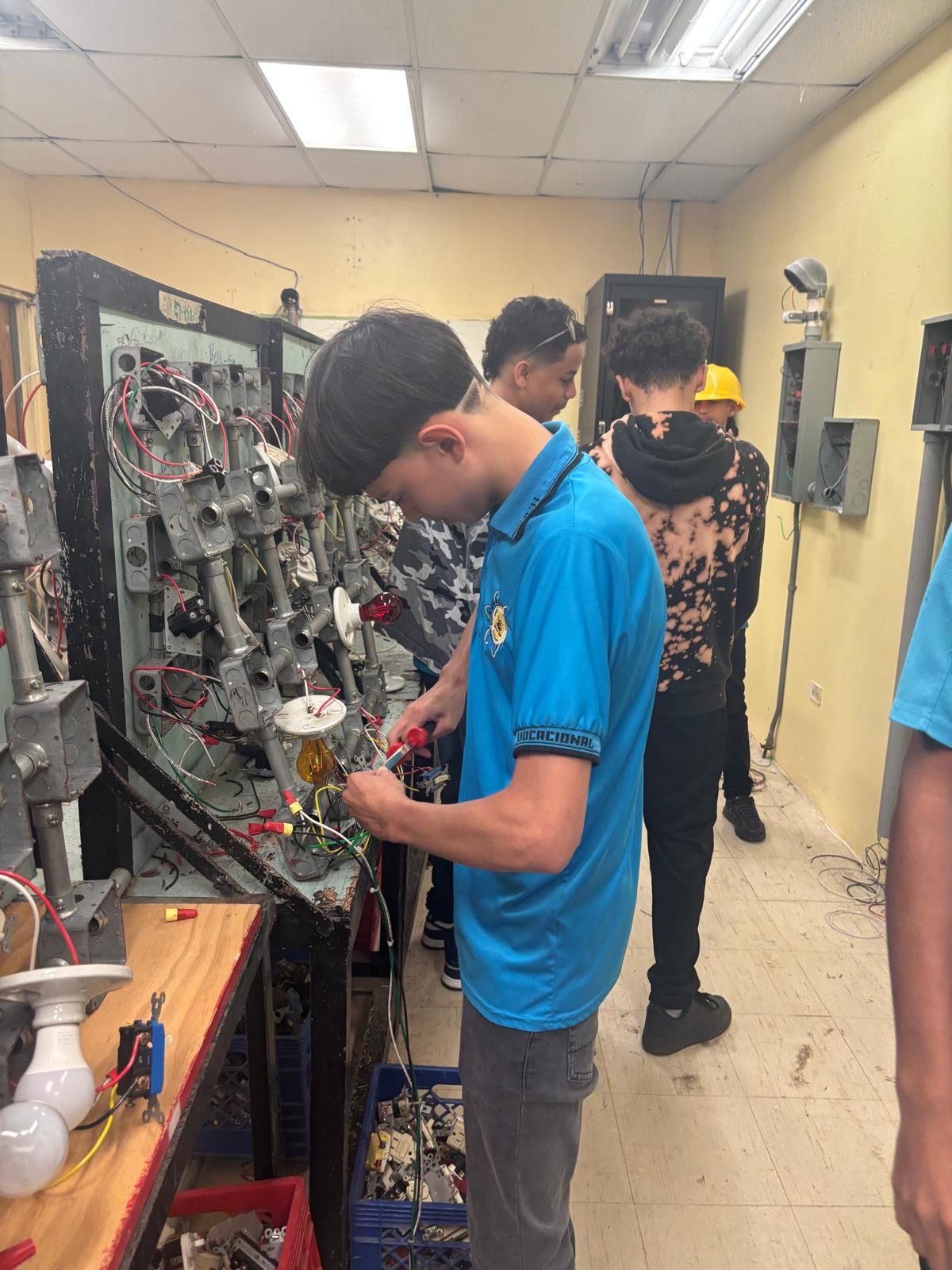 Hands-on wiring and electrical connections practice in the workshop